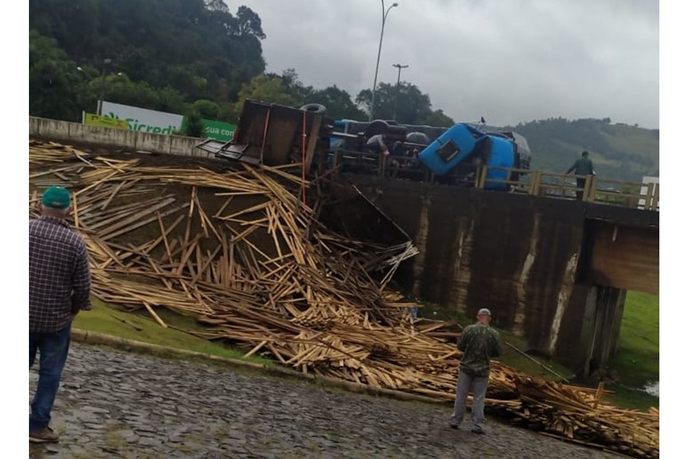 Caminhão carregado com madeira tomba na ponte do Goio-Ên e deixa duas pessoas feridas